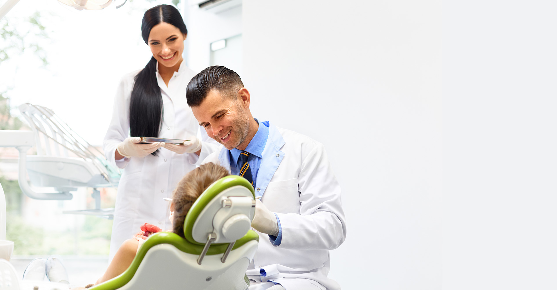 Two dental practicioners talking to a patient